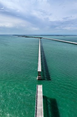 Güneşli bir günde Bahia Honda Demiryolu Köprüsü 'nün havadan görünüşü. Bahia Honda Demiryolu Köprüsü, Florida Keys 'te Bahia Honda Key' i İspanyol Limanı Anahtarı 'na bağlayan terk edilmiş bir demiryolu köprüsü.