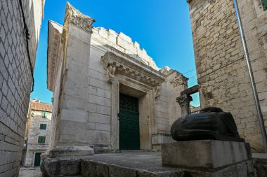 Front gate of the temple of Jupiter in the Diocletian's Palace in Split, Croatia, beautiful restored historic building with green door and guarded by Egyptian sphinx clipart