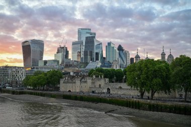 London, UK - Jun 23, 2024: Financial district of London, England at dusk from the Tower Bridge. clipart