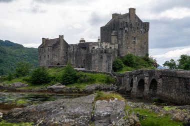 İskoçya 'nın Highlands bölgesinde Dornie, İngiltere yakınlarındaki Loch Duich, Loch Long ve Loch Alsh arasındaki gelgit adasında yaya köprüsüne sahip Eilean Donan şatosu.