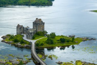 Eilean Donan castle with connecting footbridge on a tidal island between Loch Duich, Loch Long and Loch Alsh in Highlands of Scotland, near Dornie, UK clipart