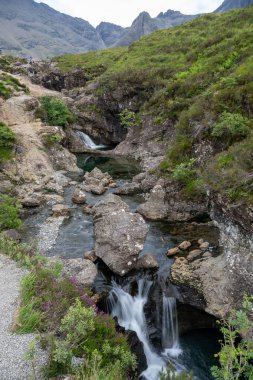 Ethereal Beauty of Fairy Pools Under the Majestic Skye Mountains of Scotland. clipart