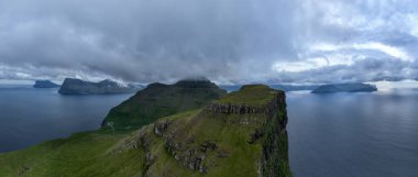 Hills by the Kallur lighthouse of Kalsoy island, Faroe Islands, Denmark. clipart