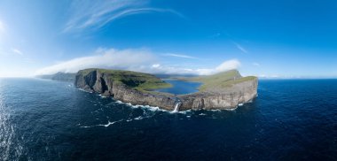 Bosdalafossur waterfall, that falls directly into the ocean. Sorvagsvatn Lake in Vagar, Faroe Islands, Denmark, Europe. clipart