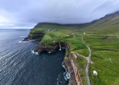 Faroe Adaları 'ndaki Gasadalur Köyü ve Mulafossur Şelalesi' nin hava manzarası.