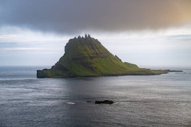 Drangarnir and Tindholmur Islands in Vagar in the Faroe Islands. clipart