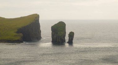 Drangarnir in Faroe Islands Vagar, aerial drone view in North Atlantic Ocean. Faroe Islands, Denmark, Europe. clipart