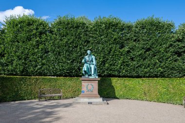 Copenhagen, Denmark - Jul 27, 2024: Statue of Hans Christian Andersen a danish writer of many fairy tales for children. clipart