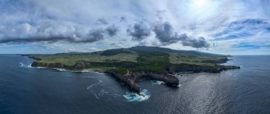 Volcanic lava-formed coastal cliffs at Alagoa Viewpoint, northern coast of Terceira, Azores. clipart