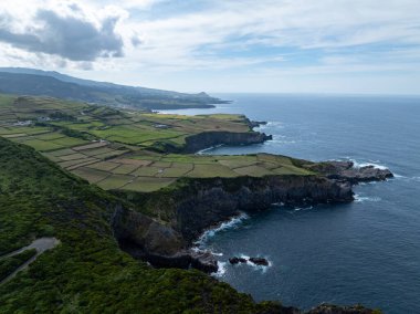 Volcanic lava-formed coastal cliffs at Alagoa Viewpoint, northern coast of Terceira, Azores. clipart