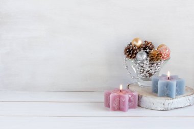 Noel süslemesi, koni kompozisyonu, yeni yıl boncukları, mumlar ve beyaz bir masada noel topları, kopyalama alanı. Yüksek kalite fotoğraf