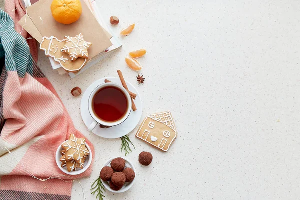 Aesthetic background with coffee, tangerines, homemade cookies, truffles and books. Atmospheric Christmas good mood background.