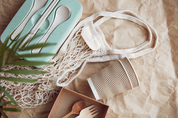 Natural, eco-friendly, plastic free, zero waste tableware. Eco shopping bag on crumpled paper. Sustainable lifestyle.