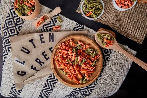 Gluten free green pea and carrot fusilli pasta with whole grain wheats. Organic healthy food for people with lactose intolerance. Gluten free text