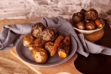 Healthy baked vegetables - carrots, potatoes, beetroot, rustic background. Whole food diet, Dash diet.