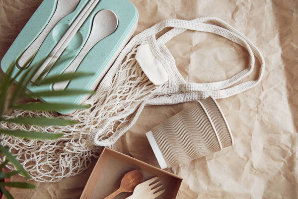 Natural, eco-friendly, plastic free, zero waste tableware. Eco shopping bag on crumpled paper. Sustainable lifestyle.