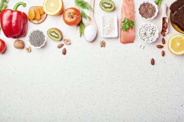Aesthetics low FODMAP concept with copy space in center. Low diet - fruits,vegetables, greenery, nuts, beans, flax seeds, chia seeds, wholegrain bread. Flat lay.