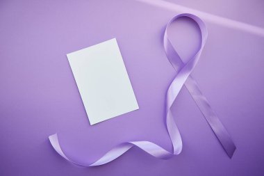 Mock of stationery card and purple ribbon for Purple Day - World Epilepsy Day, March of 26. Symbol of Epilepsy Day. 