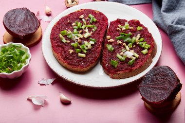 Vegetarian healthy beetroot sandwiches with young onion, garlic and cottage cheese close up. Seasonal food.
