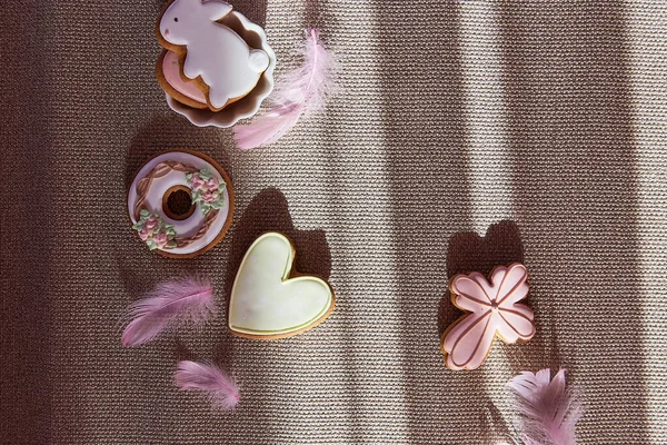 Easter trendy aesthetic with shadows background. Traditional glazing cookies. Easter food.