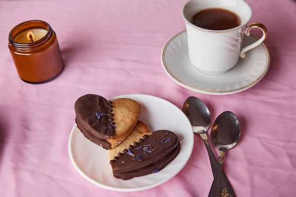 Vegan heart shaped cookies - aesthetics pink Valentines day flat lay, coffee and candle.