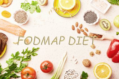 FODMAP diet with text in center. Mediterranean healthy low ingredients - vegetables, greenery, fruits, nuts, beans, egg, flax seeds, chia seeds. Flat lay. clipart