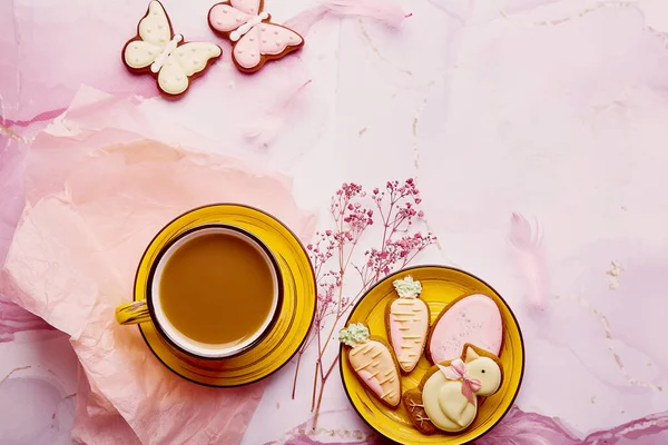 Pastel aesthetic Easter table with copy space. Homemade cookies and coffee flat lay. Springtime background.