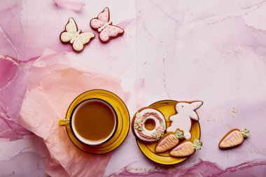 Aesthetic seasonal Easter holiday with copy space flat lay. Homemade cookies and coffee cup. Springtime background.