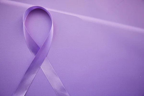 Purple ribbon for Purple Day - World Epilepsy Day, March of 26. Symbol of Epilepsy Day on purple background with shadows.
