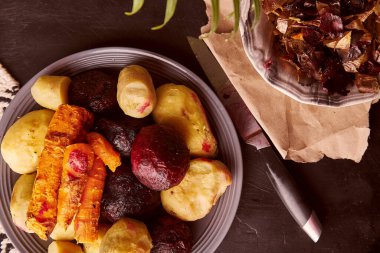 Peeled baked vegetables - baked potatoes, carrots, beetroot on rustic background. Whole food diet, Mediterranean diet