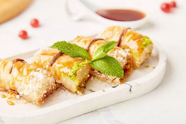 Traditional turkish delight of baklava with honey and mint. Natural sweets close up.