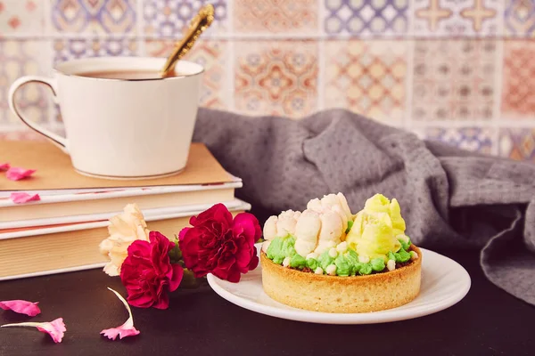 Hygge home aesthetic. Floral french tart with flowers. Desserts using the trend Dreamy Escapism. Pink floral cake and coffee, guilty pleasure.