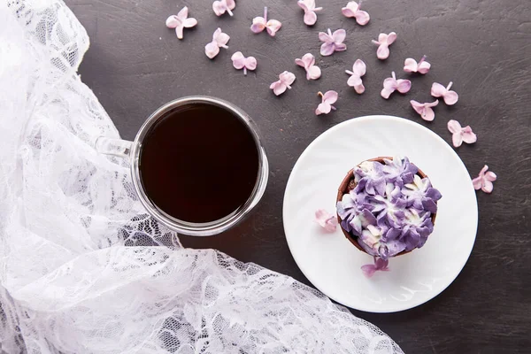 Floral purple no sugar french cupcake. Dessert, coffee and lilac flowers background. Aesthetics food flat lay.