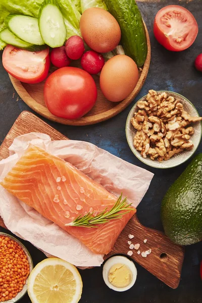 stock image Organic healthy low fodmap food ingredients - vegetables, fruits, walnuts, smoked salmon, greens. Top view.