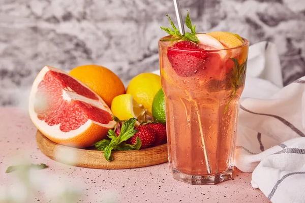 Aesthetic summer bright grapefruit, strawberry cocktail drink. Summer refreshing detox vitaminized cocktail.