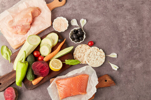 Aesthetic healthy low fodmap food - vegetables,lemon, smoked salmon, greens, ingredients. Top view, copy space