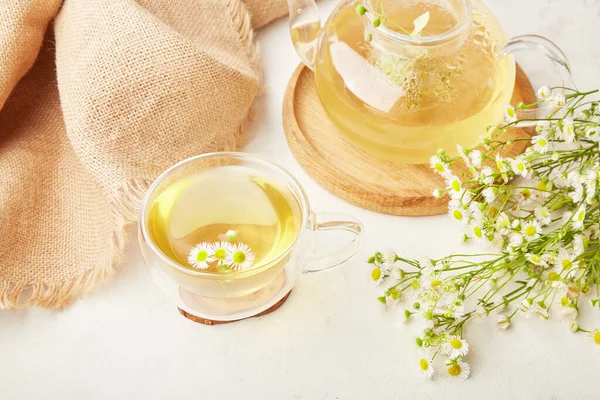 Aesthetic organic herbal chamomile tea. Summer table setting, natural healthy drink.