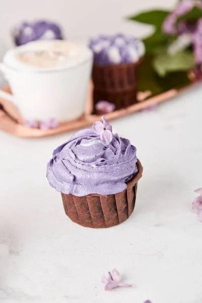 Floral purple cupcake, Dreamy Escapism trend. Aesthetics desserts coffee cup. Catering food.