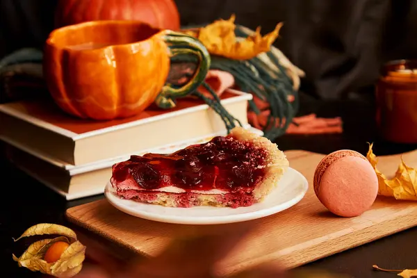Aesthetics cozy home breakfast - cherry pie, cup of coffee in shape of pumpkin, macaroons, candle and winter cherry. Hygge home aesthetic.