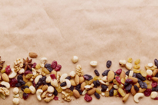 Aesthetics assorted nuts mix in line with copy space. Walnuts, almonds, hazelnuts and cashews, raisins and cranberries. Healthy food and snacks