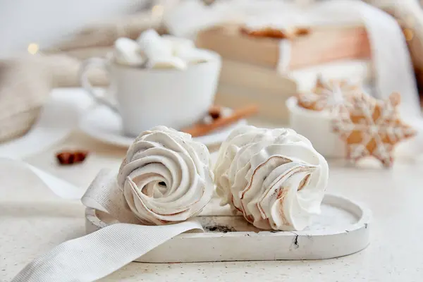 Aesthetics delicate marshmallow, hot cocoa, ginger homemade cookies at cozy home. Aesthetic white Christmas background.