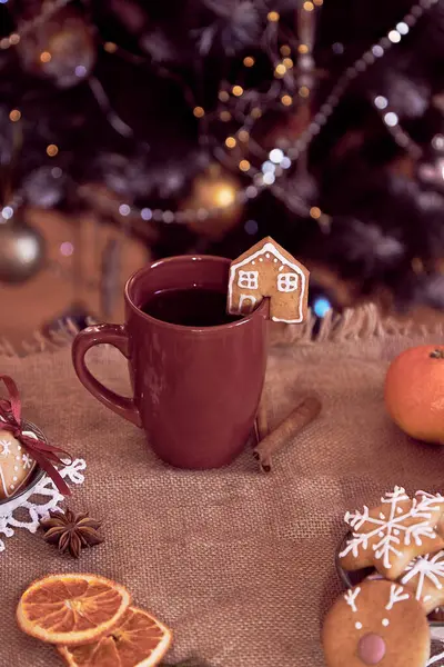 Winter table settting. Aesthetics Christmas food - ginger cookies houses and hot cocoa. Cozy warm home. Christmas background.