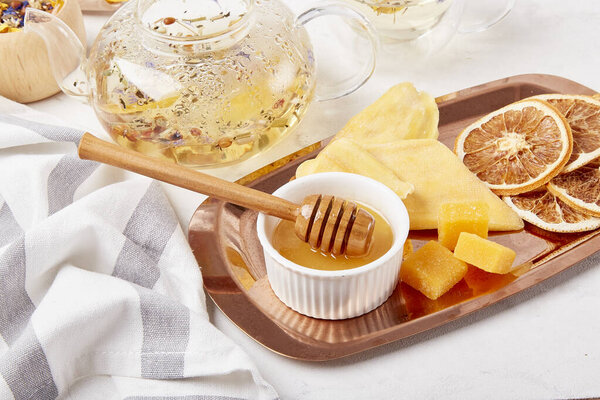 Aesthetic tea time, herbal tea table setting with natural honey close up. Natural organic tea - natural sustainable eco-friendly lifestyle. Soothing tea ceremony vibes