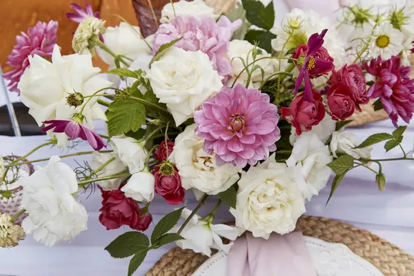 Vibrant bouquet with mix of pink dahlias and white roses. Floral design inspiration and botanical art.