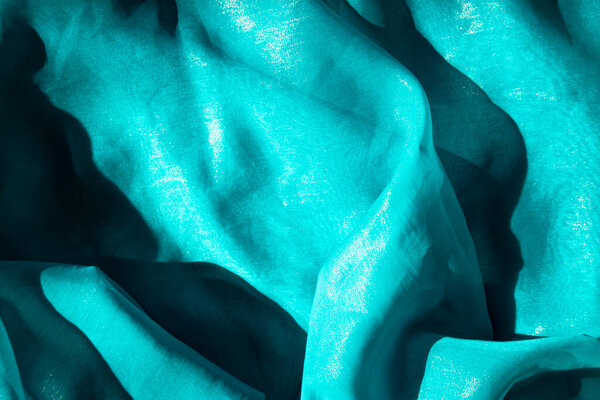 Luminous depths - shimmering aqua fabric patterns.