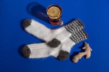 warm woolen white cozy hand-knitted socks. Still life. Flat lay.