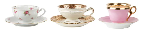 Stock image drink me! - set of three fancy old-fashioned tea or coffee cups isolated over a white background, white with rose pattern, golden and pink with gold border, cut out beverage design elements