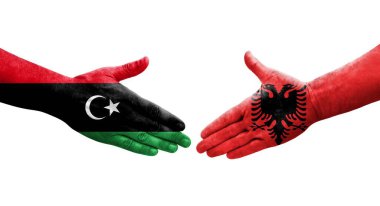 Arnavutluk ile Libya bayrakları arasındaki el sıkışma, izole edilmiş şeffaf görüntü.