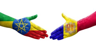 Andorra ve Etiyopya bayrakları arasındaki el sıkışma ellerinde izole şeffaf görüntü.