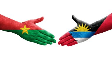 Antigua ve Barbuda ile Burkina Faso bayrakları arasındaki el sıkışma, izole şeffaf görüntü.